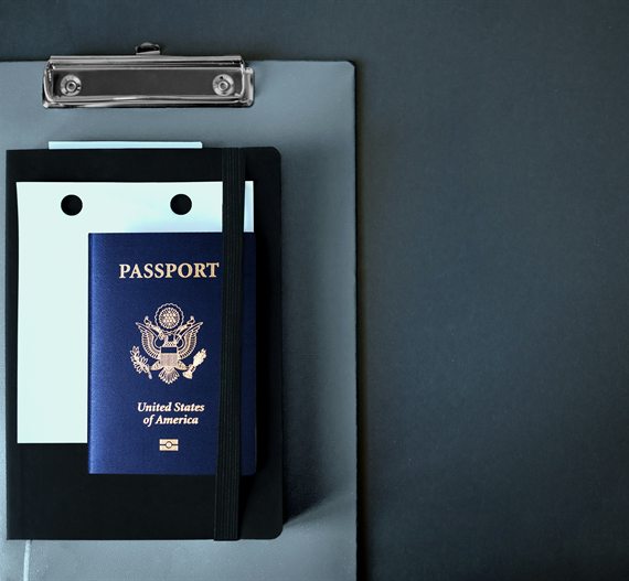 Passport and application documents on a clipboard