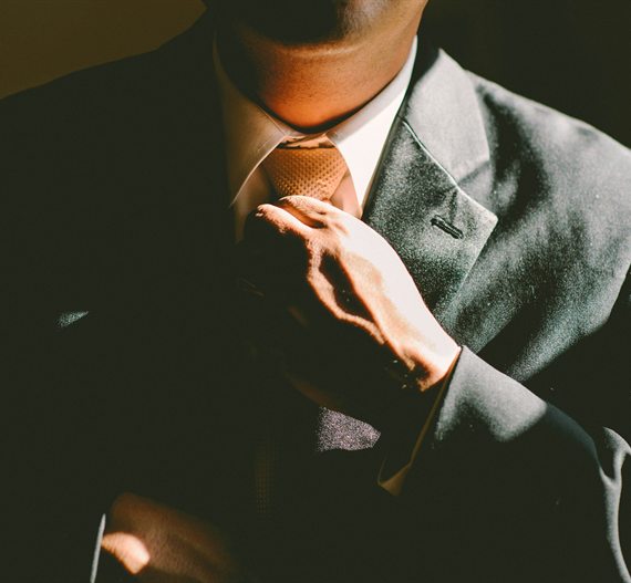 Businessman adjusting his tie